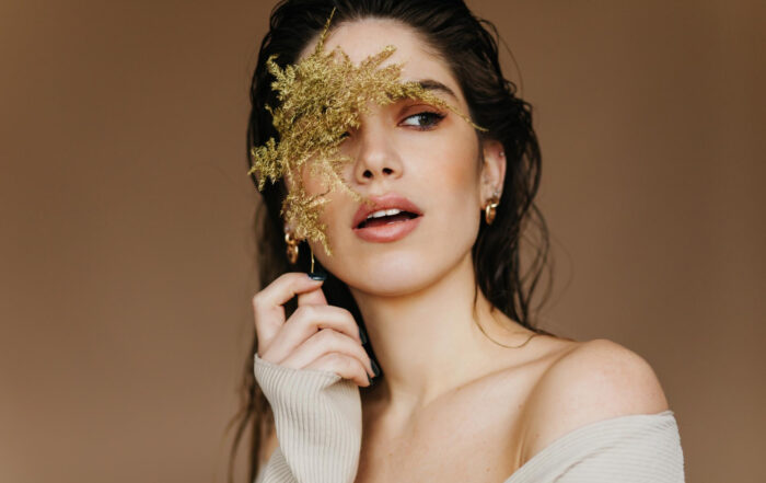 spectacular young woman with black hair holding flower romantic pale girl posing studio with plant 1